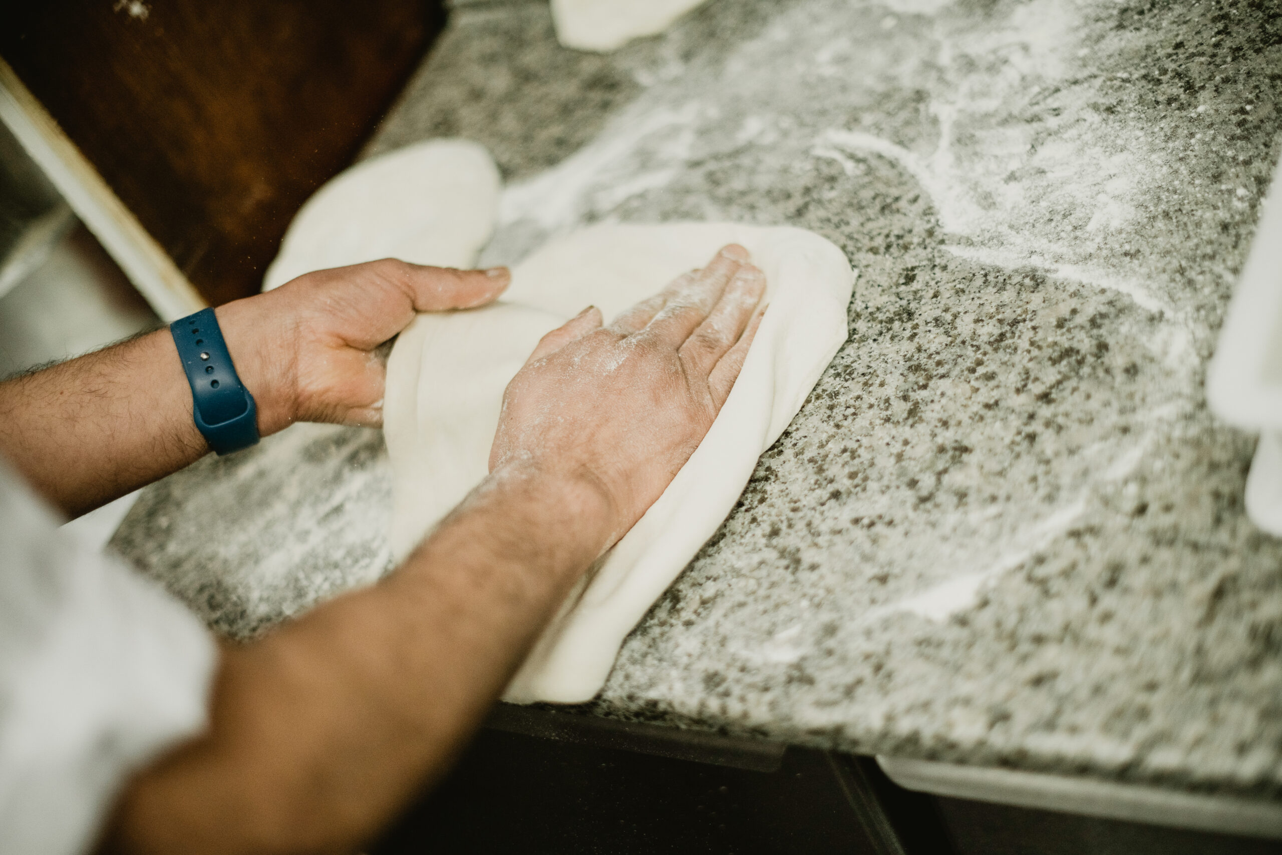 Rolling out Pizzeria Villaggio pizza dough